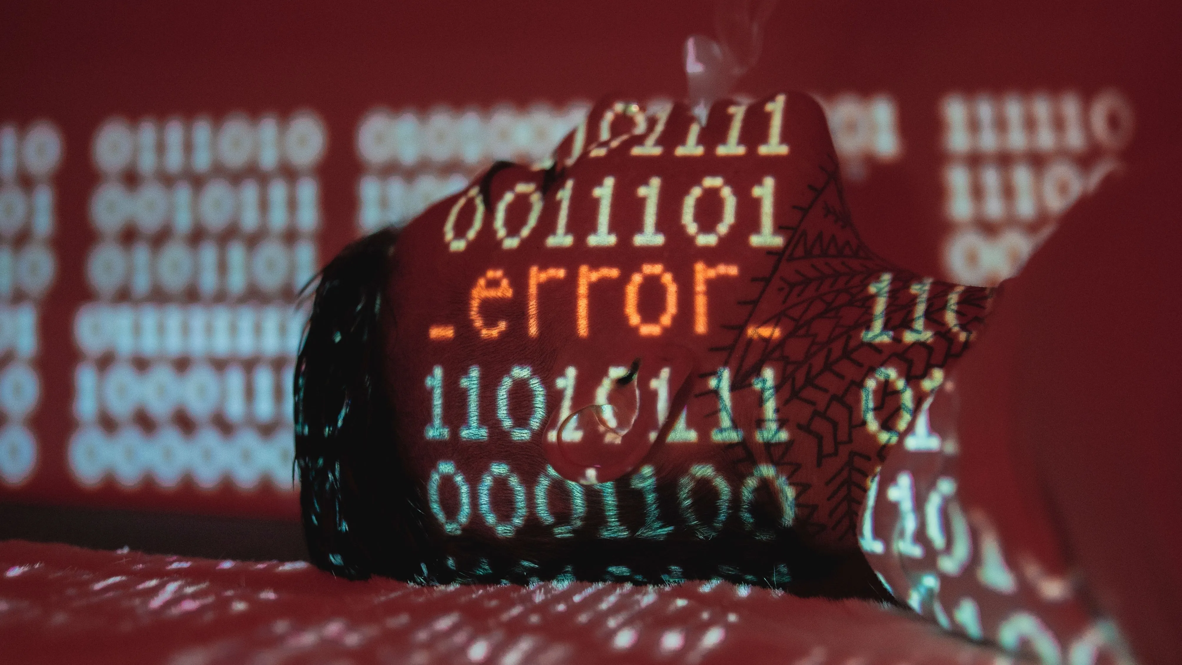 A conceptual image showing error code projected on binary data with smoke.